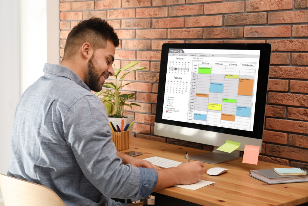 Man uses calendar platform on his computer